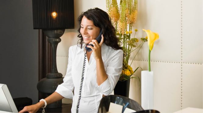 woman on a business phone at upscale front-desk lobby